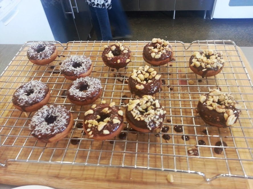 A picture of vegan donuts on a cooling rack.