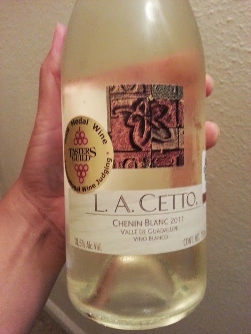 Hand holding a bottle of L.A. Cetto