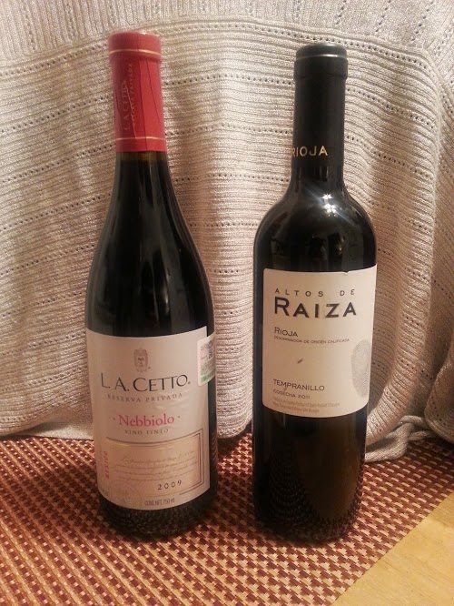 Two bottles of red wines side by side.