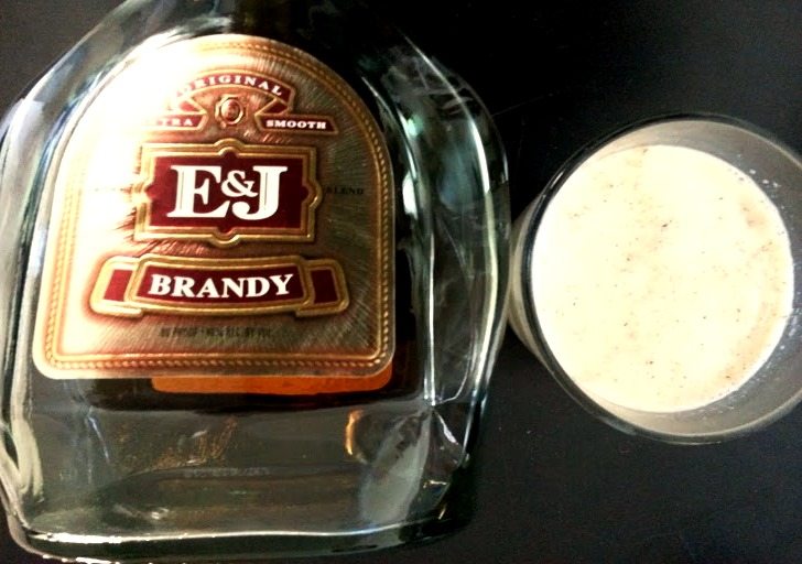 Brandy bottle next to a glass of milk