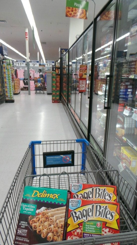 shopping cart with bagel bites and delimex taquitos at Walmart