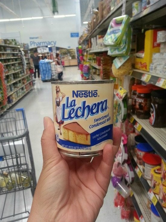Holding a can of La Lechera 