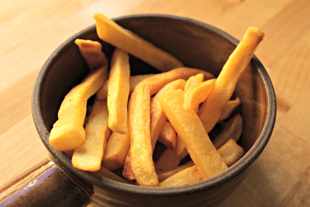 French fries in a brown bowl.