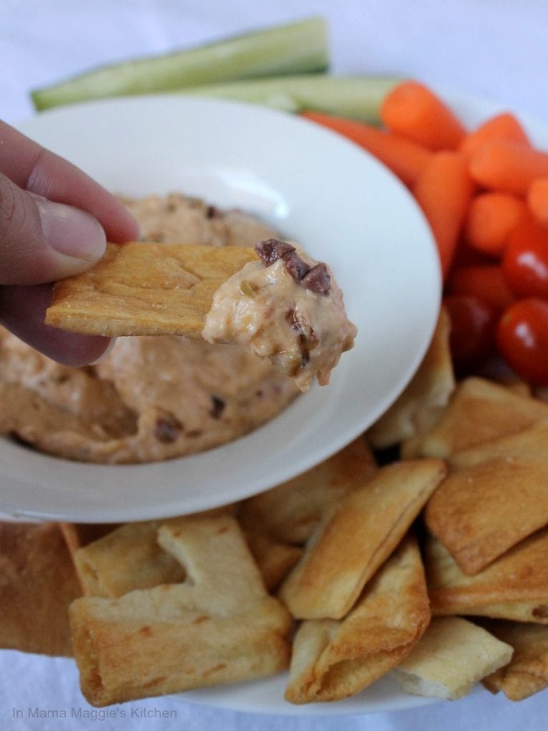 Dipping Bread in White Bean and Olive Dip