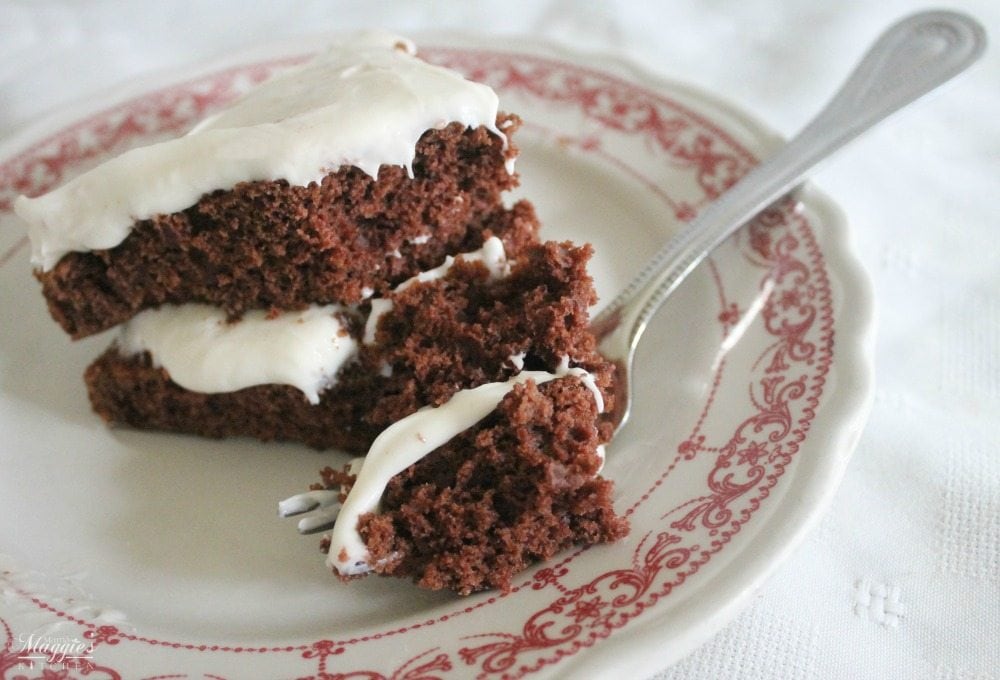Chocolate Cake with Cream Cheese Frosting  served in a plate with a fork