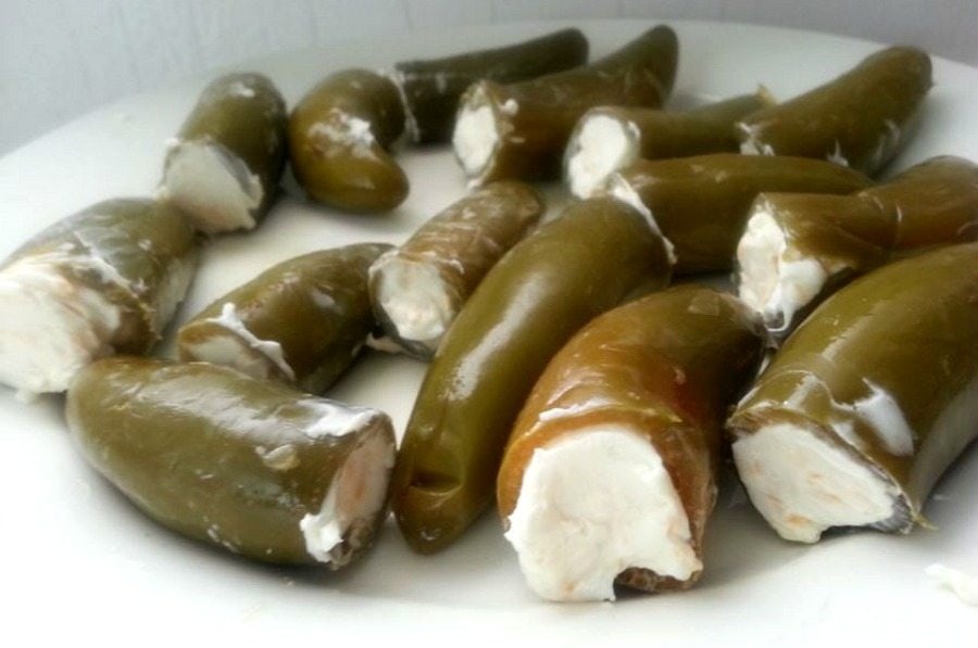 Jalapenos stuffed with cream cheese in a plate