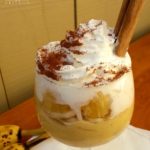 Banana Pudding Parfait served on a glass and sprinkled with ground cinnamon.
