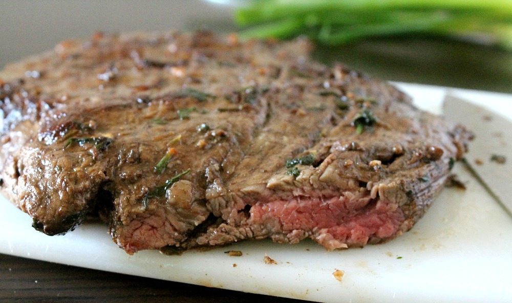 Grilled Balsamic Herb Steak in a cutting board