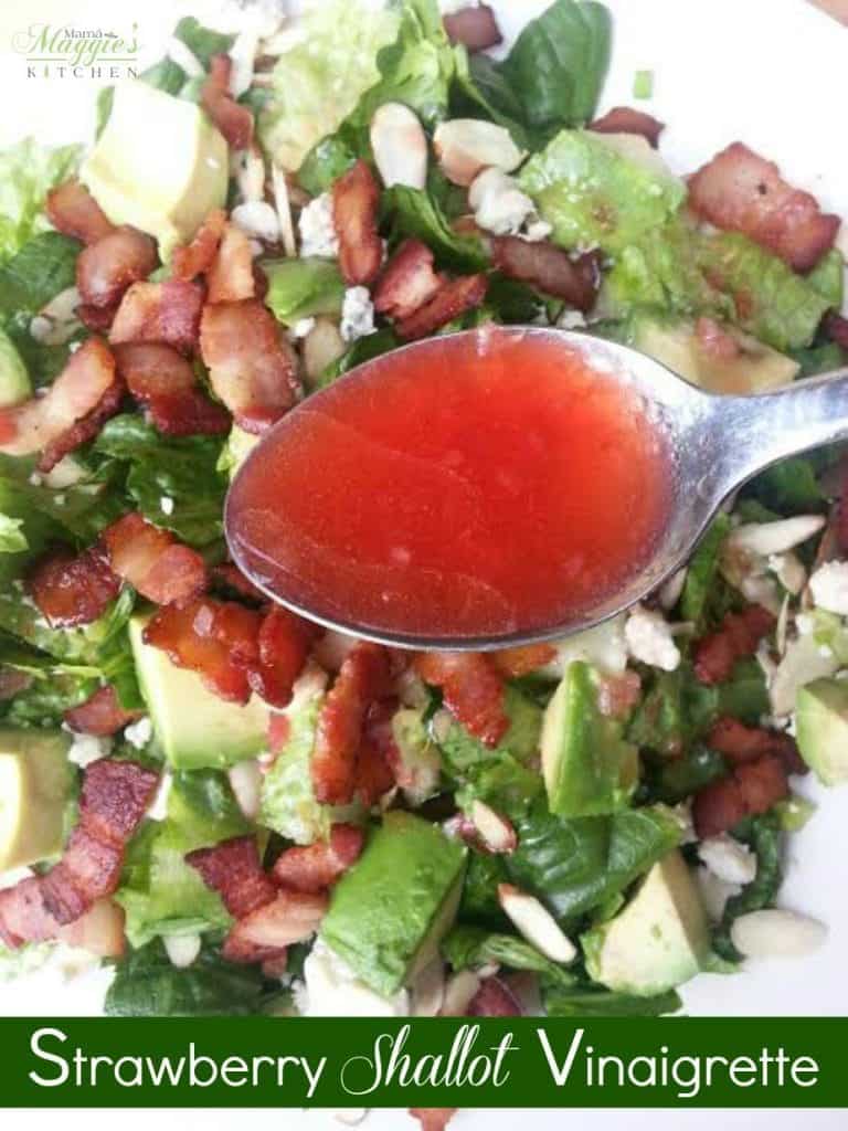 Low Calorie Salad Dressing: Strawberry Shallot Vinaigrette in a spoon and a salad in the bacground