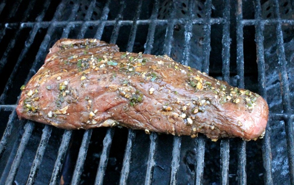 Tri Tip grilling on a BBQ grill.