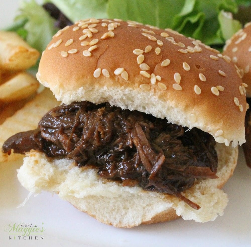 Slow Cooker BBQ Beef Sliders are miniature, itty bitty bites of goodness. Only 5 ingredients and minimal work will get you, your family, and your guests fed. Enjoy! By Mama Maggie’s Kitchen 