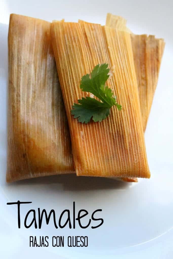 Tamales Rajas con Queso, or Jalapeño and Cheese Tamales on a white plate topped with a green cilantro leaf.