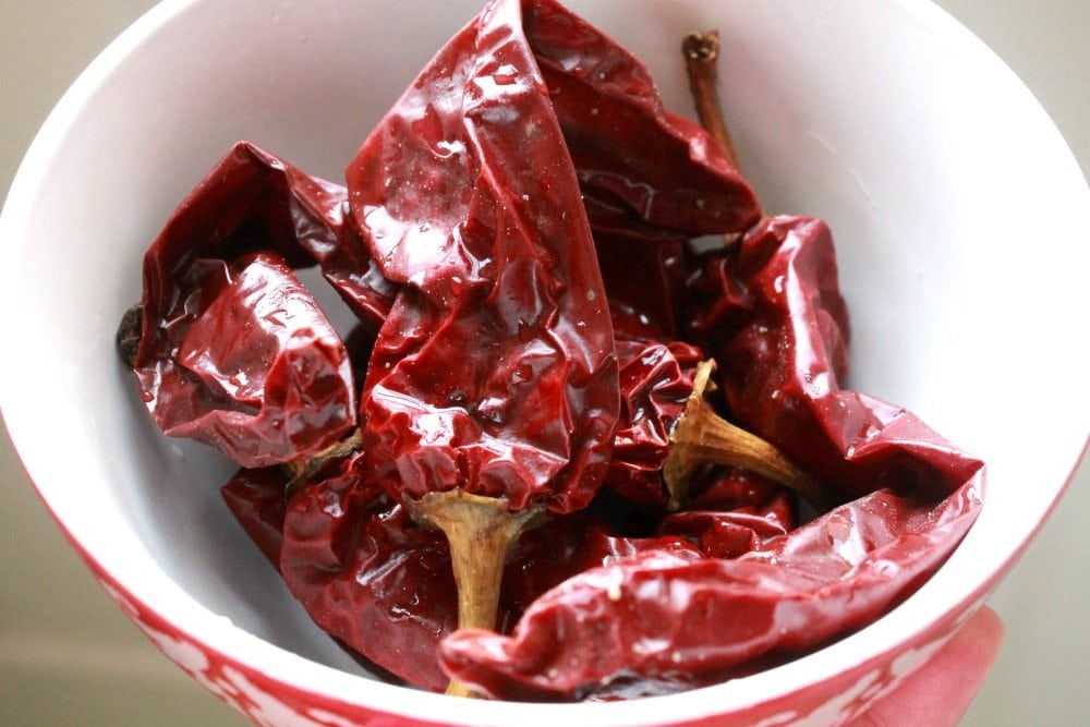 A picture of dried guajillo chile in a red bowl.