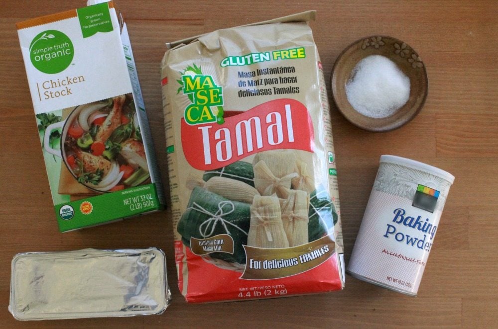 Ingredients needed to make masa on a wooden table.