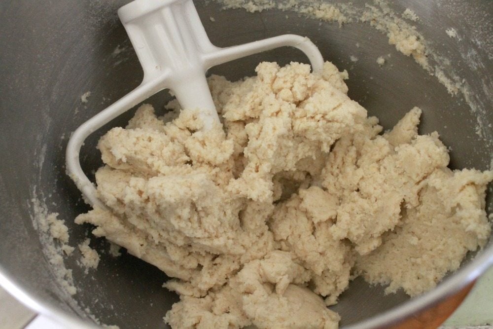 Masa in a mixing bowl with a mixing attachment.