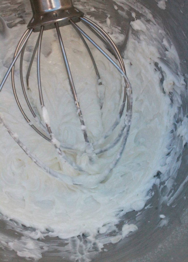 Whipped shortening with a handle in a metal mixer.