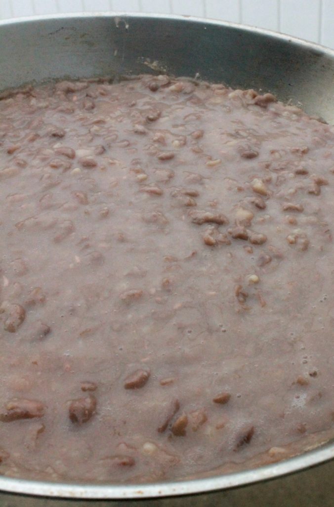 Refried Beans, or Frijoles Refritos, in a metal skillet.