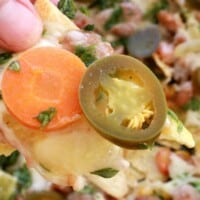 Baked Vegetarian Nachos make the best weeknight meal. This dish comes together fast and uses up leftovers. By Mama Maggie’s Kitchen