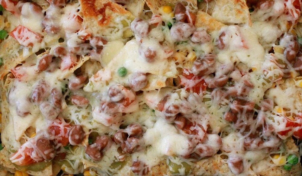 Baked Vegetarian Nachos make the best weeknight meal. This dish comes together fast and uses up leftovers. By Mama Maggie’s Kitchen