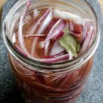 Mexican Pickled Red Onions (Cebolla Morada en Escabeche) is a yummy topping that is incredibly easy-to-make. A favorite topping in Mexico that adds a lot of flavor to your food. By Mama Maggie’s Kitchen