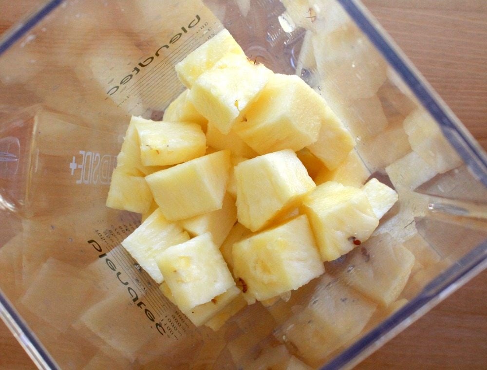 Diced pineapple in a blender.