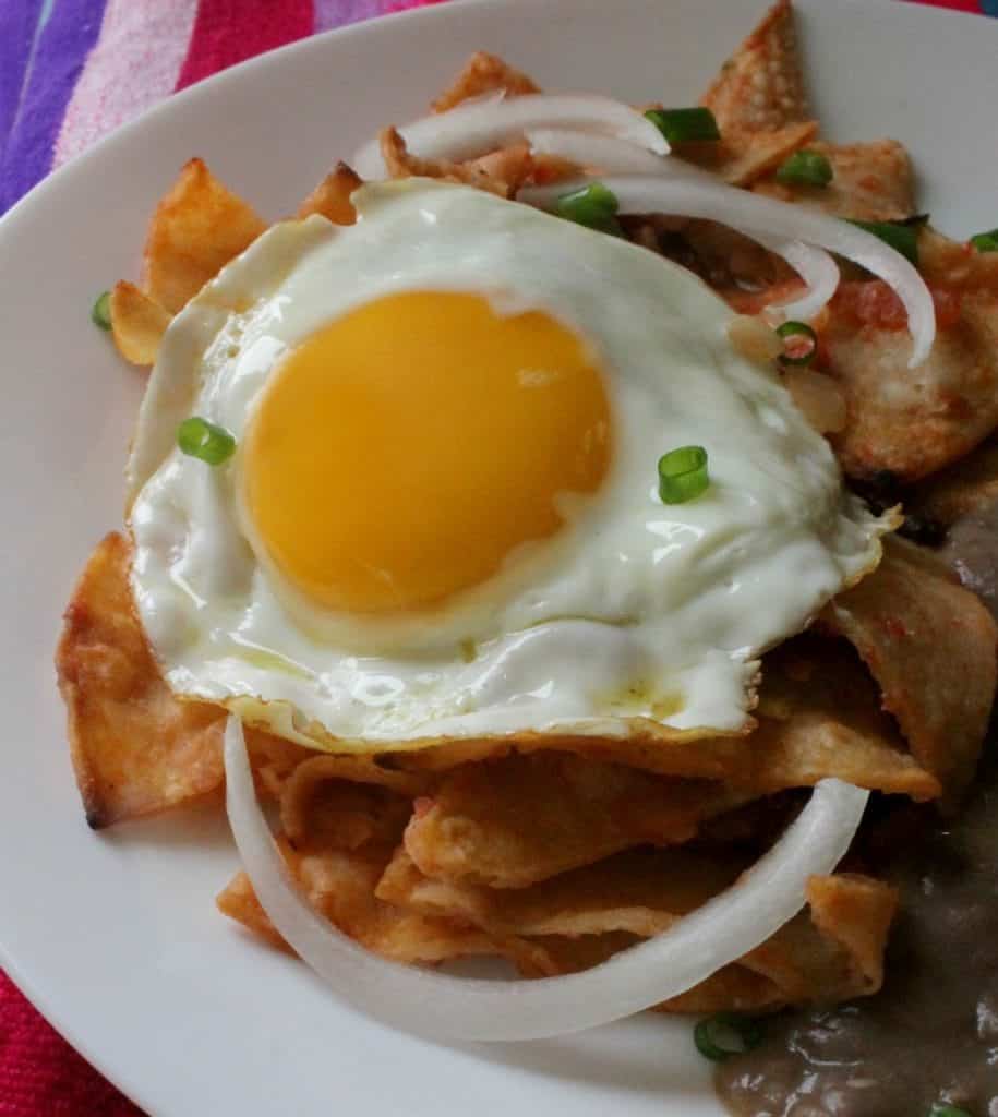 Sunday breakfast never looked better with Chilaquiles Rojos, or Red Chilaquiles. This hearty and delicious Mexican food favorite will make you want to lick your plate clean! By Mama Maggie’s Kitchen