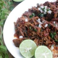 Barbacoa de Res tastes out of this world. With strong, bold flavors and meat that has been cooking for hours. Serve with tortillas, onions, avocado, and lime. Enjoy! By Mama Maggie’s Kitchen