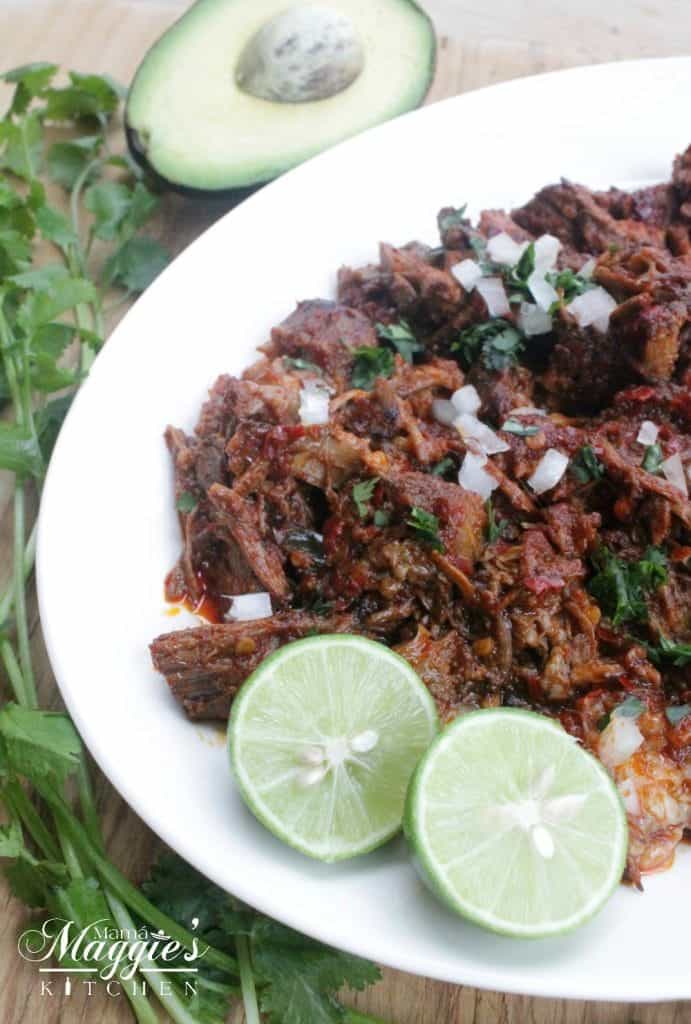 Barbacoa de Res tastes out of this world. With strong, bold flavors and meat that has been cooking for hours. Serve with tortillas, onions, avocado, and lime. Enjoy! By Mama Maggie’s Kitchen