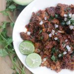Barbacoa de Res (or Beef Barbacoa) tastes out of this world. With strong, bold flavors and meat that has been cooking for hours. Serve with tortillas, onions, avocado, and lime. Enjoy! By Mama Maggie’s Kitchen