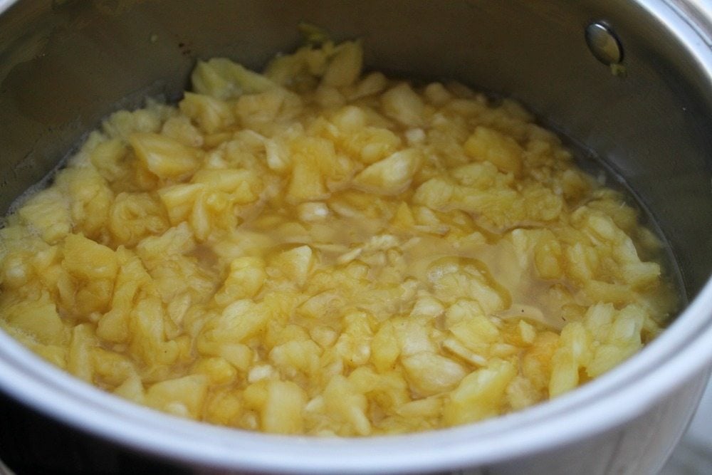 Chopped pineapple filling cooking in a pot