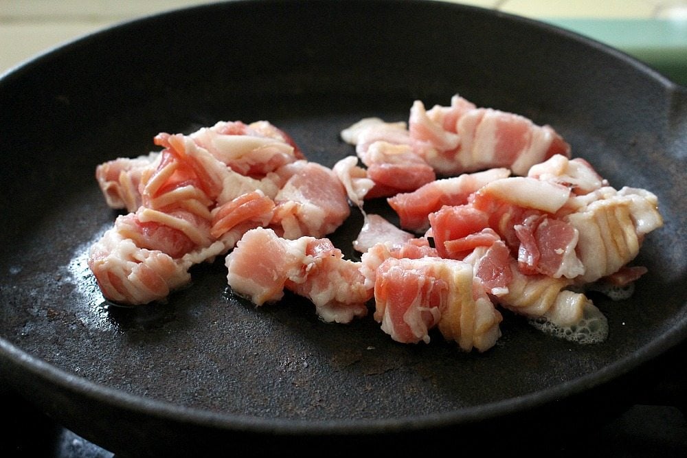 Bacon cooking in a cast iron skillet