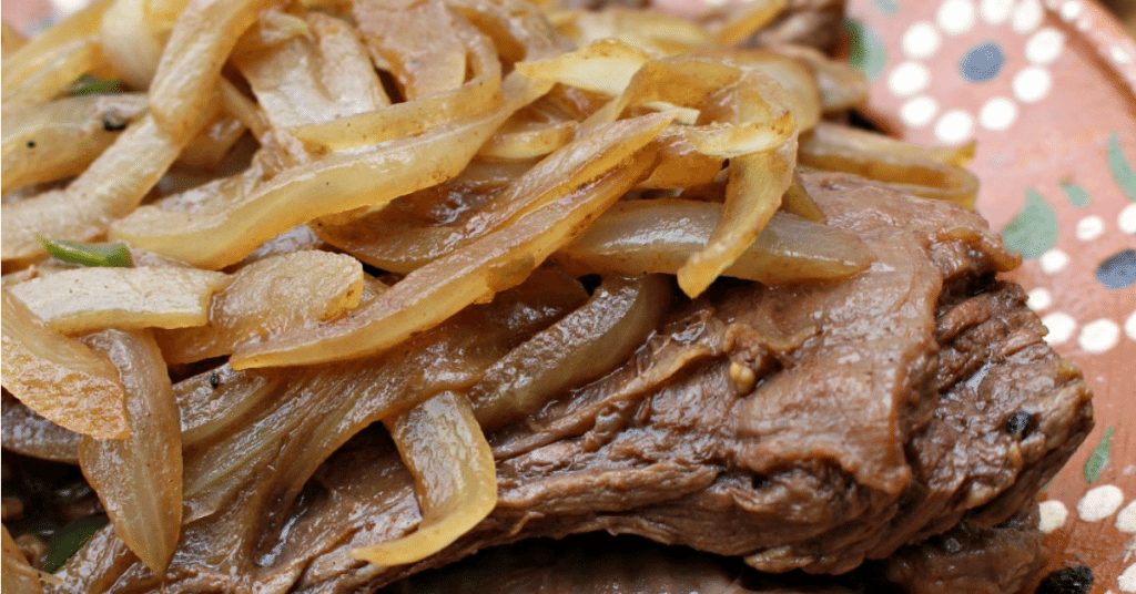 Bistec Encebollado (Mexican-Style Steak and Onions) is a tasty Mexican recipe. An easy dish made under 30 minutes, making a great weeknight meal for busy families. by Mama Maggie's Kitchen