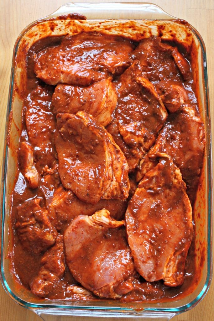 Pork Chops Marinating in Adobo Sauce in a glass container