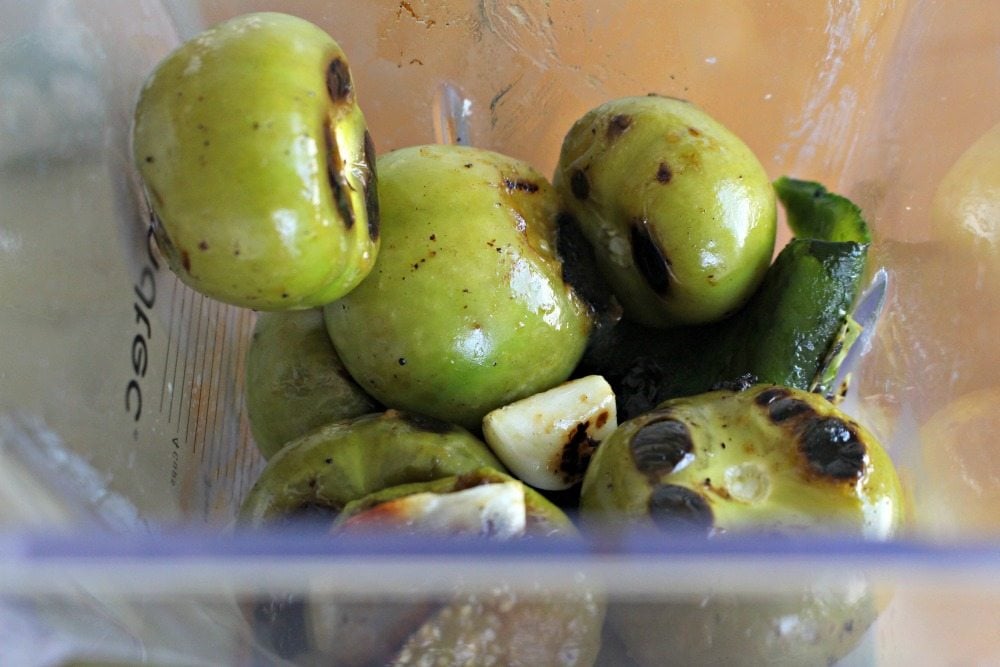 Roasted tomatillos and garlic in a blender