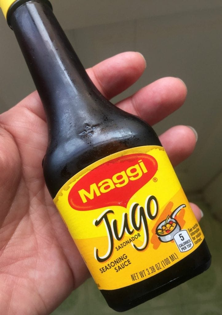 Hand holding Jugo Maggi