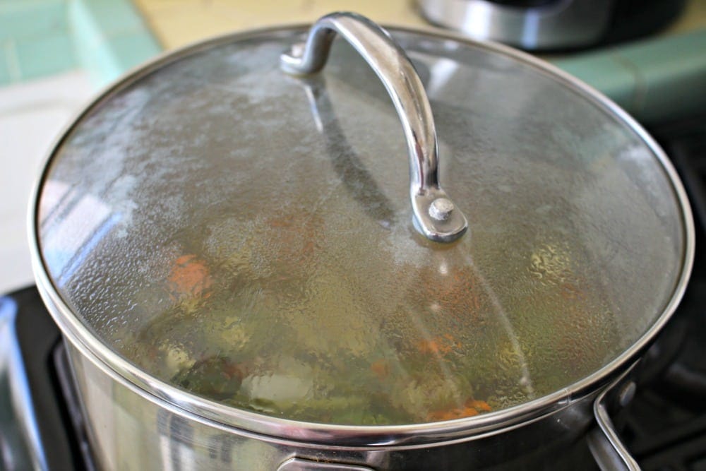 Steamy lid on a stockpot cooking on the stove.