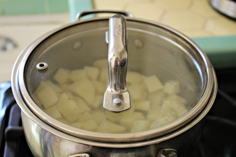 Potatoes cooking in a pot with lid on 