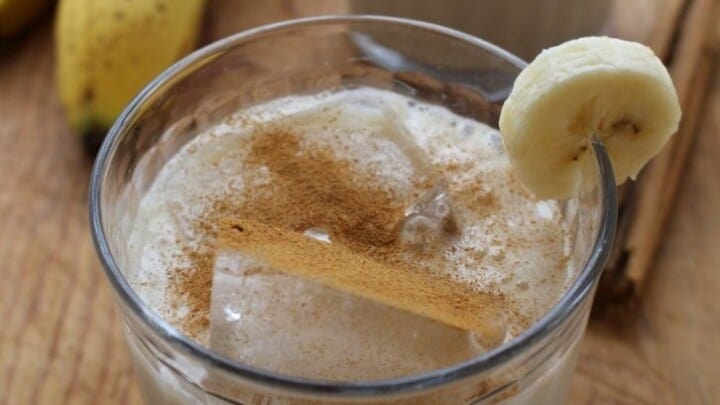 two glasses of Agua de Plátano, or Banana Agua Fresca, garnished with slices of banana