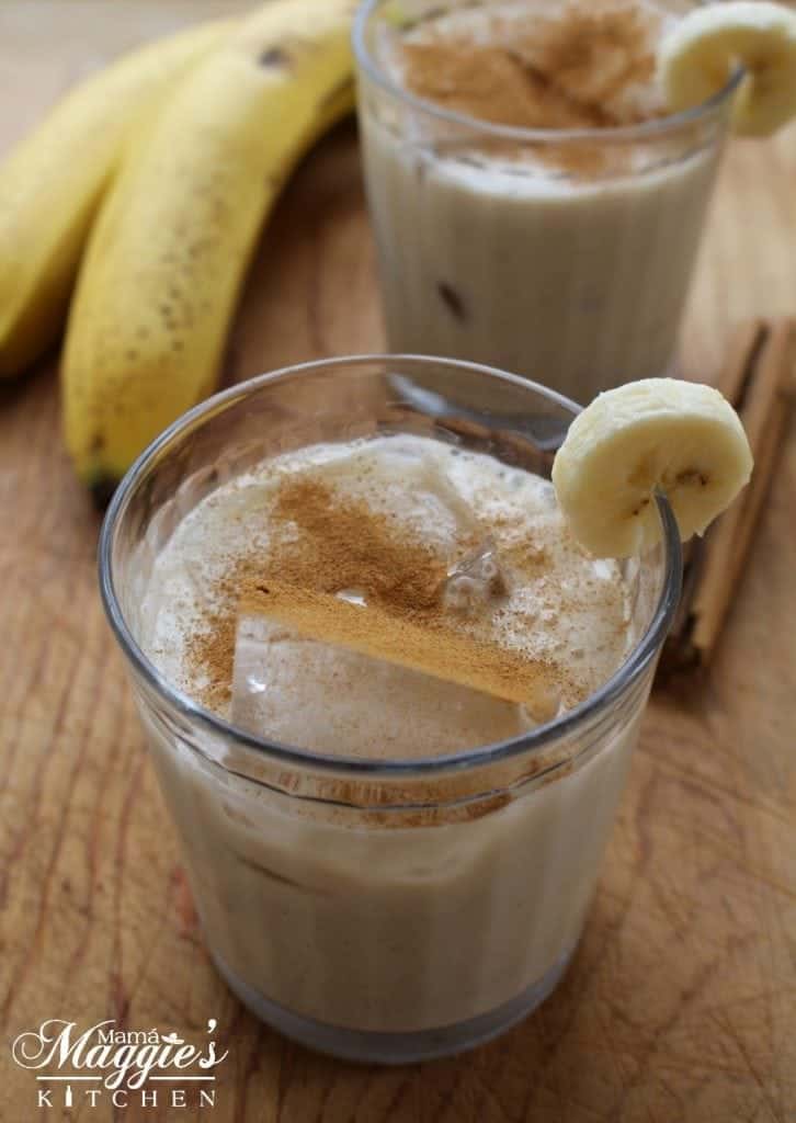 two glasses of Agua de Plátano, or Banana Agua Fresca, garnished with slices of banana