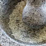 Crushing Rice in Molcajete, or Mexican Mortar and Pestle