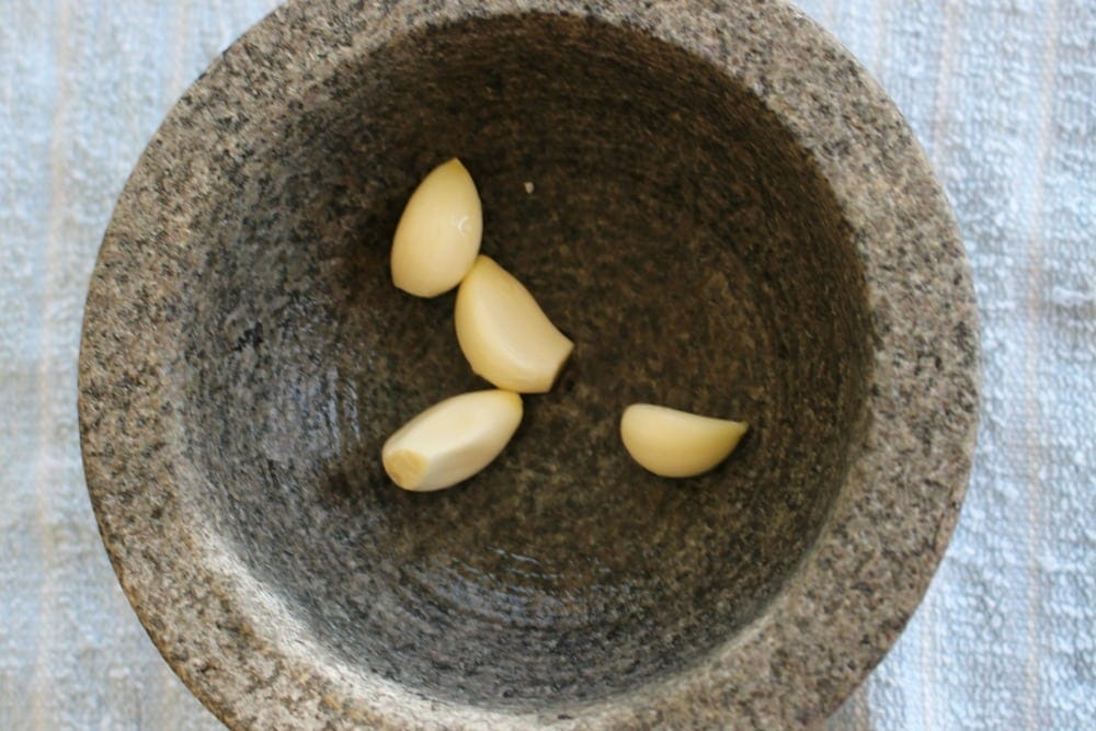 Whole garlic cloves in a molcajete