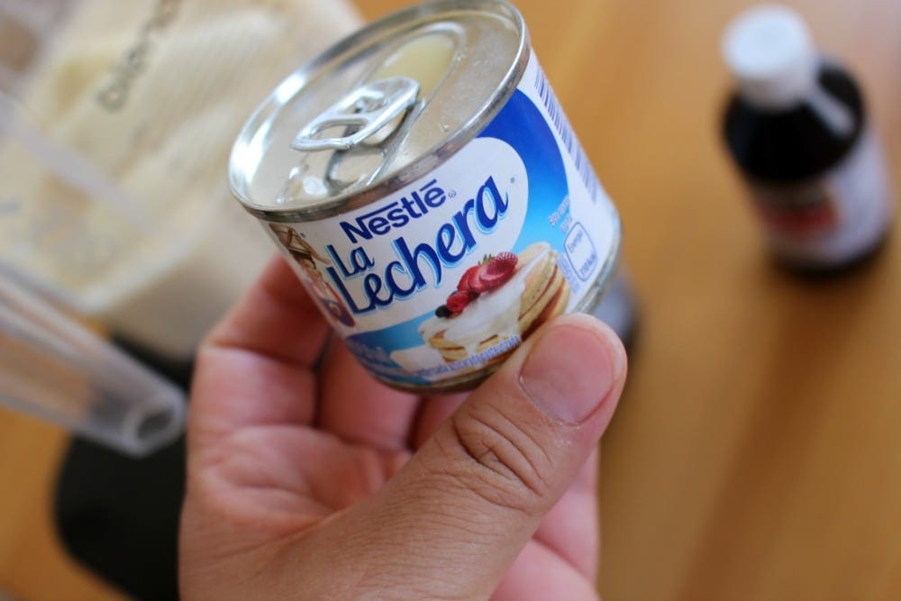 Hand holding can of sweetened condensed milk