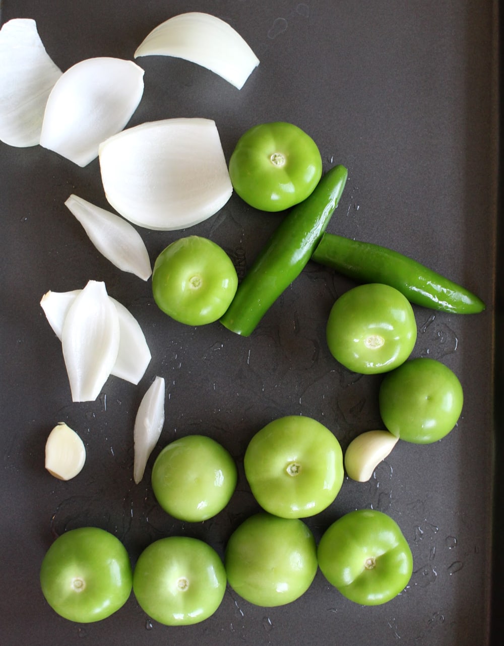 Ingredients for salsa verde on a baking sheet.