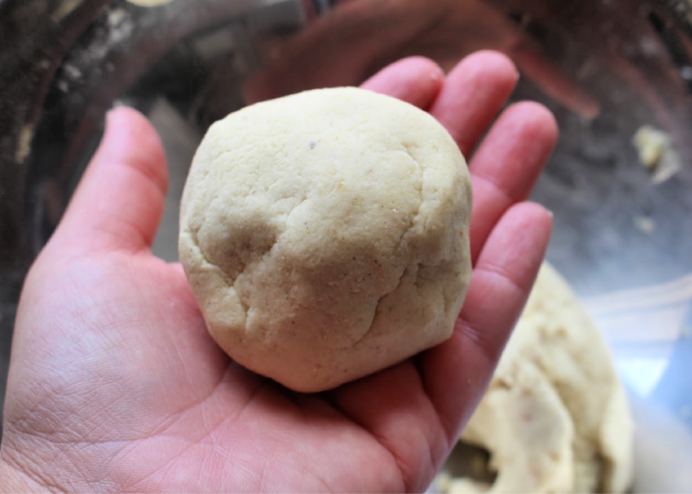 Ball of masa in a hand. 