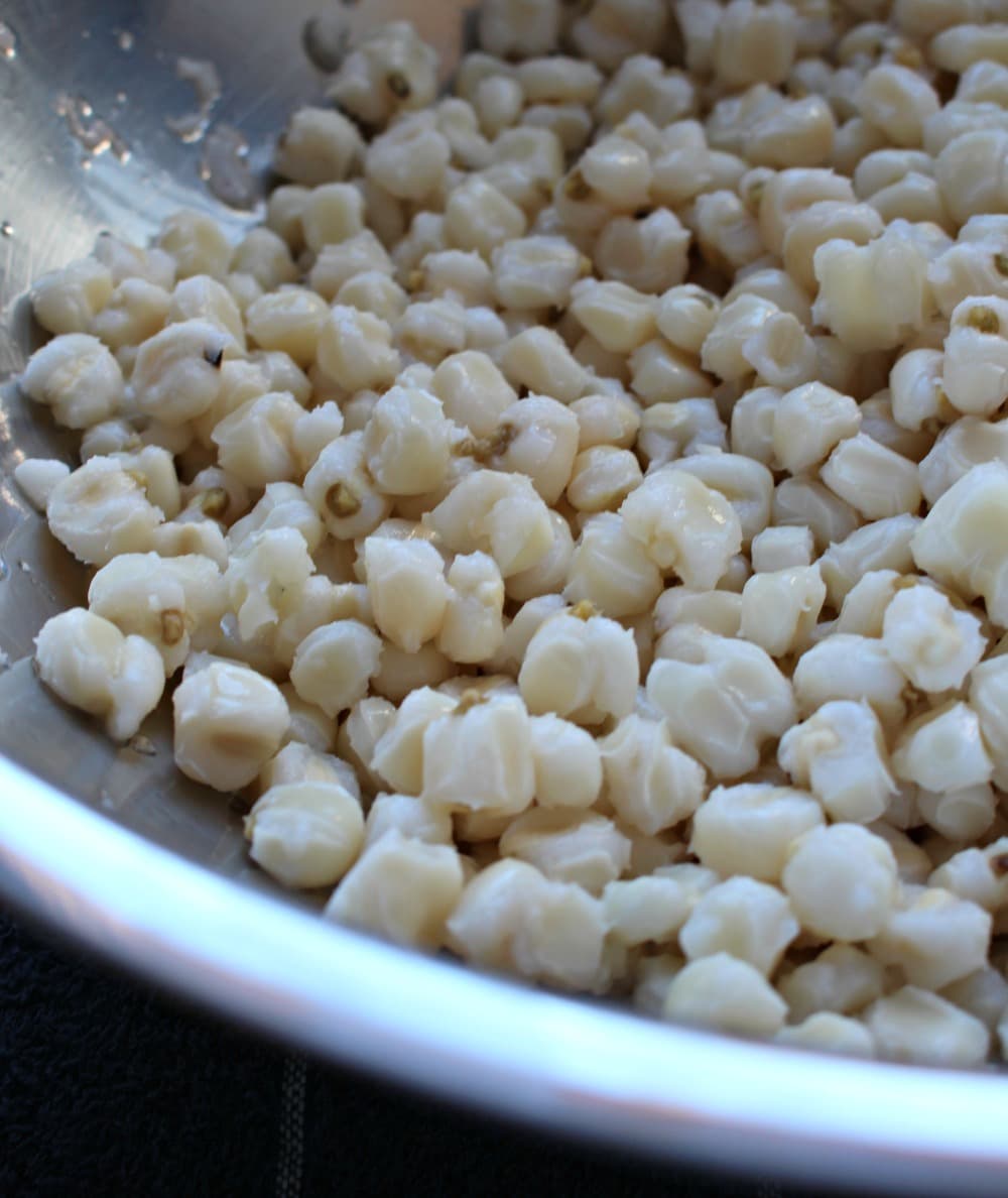 Hominy in a metal bowl.