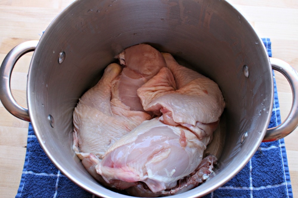 Raw chicken in a large stock pot.