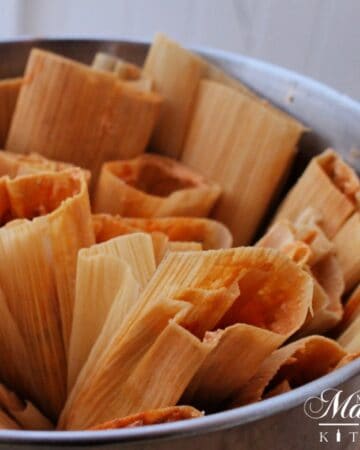 Pot of pork tamales with the open side up.