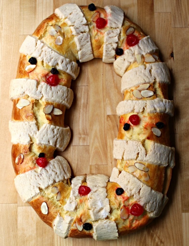 Baked Rosca de Reyes on a wooden surface.