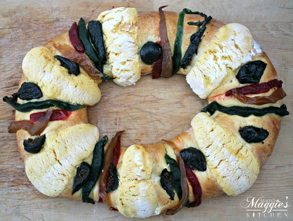 Store-bought Rosca de Reyes, or King's Cake, with different dried fruits used as toppings.