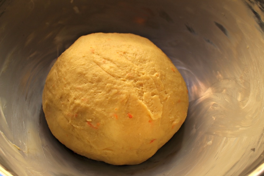 Dough for Rosca de Reyes in a buttered bowl.